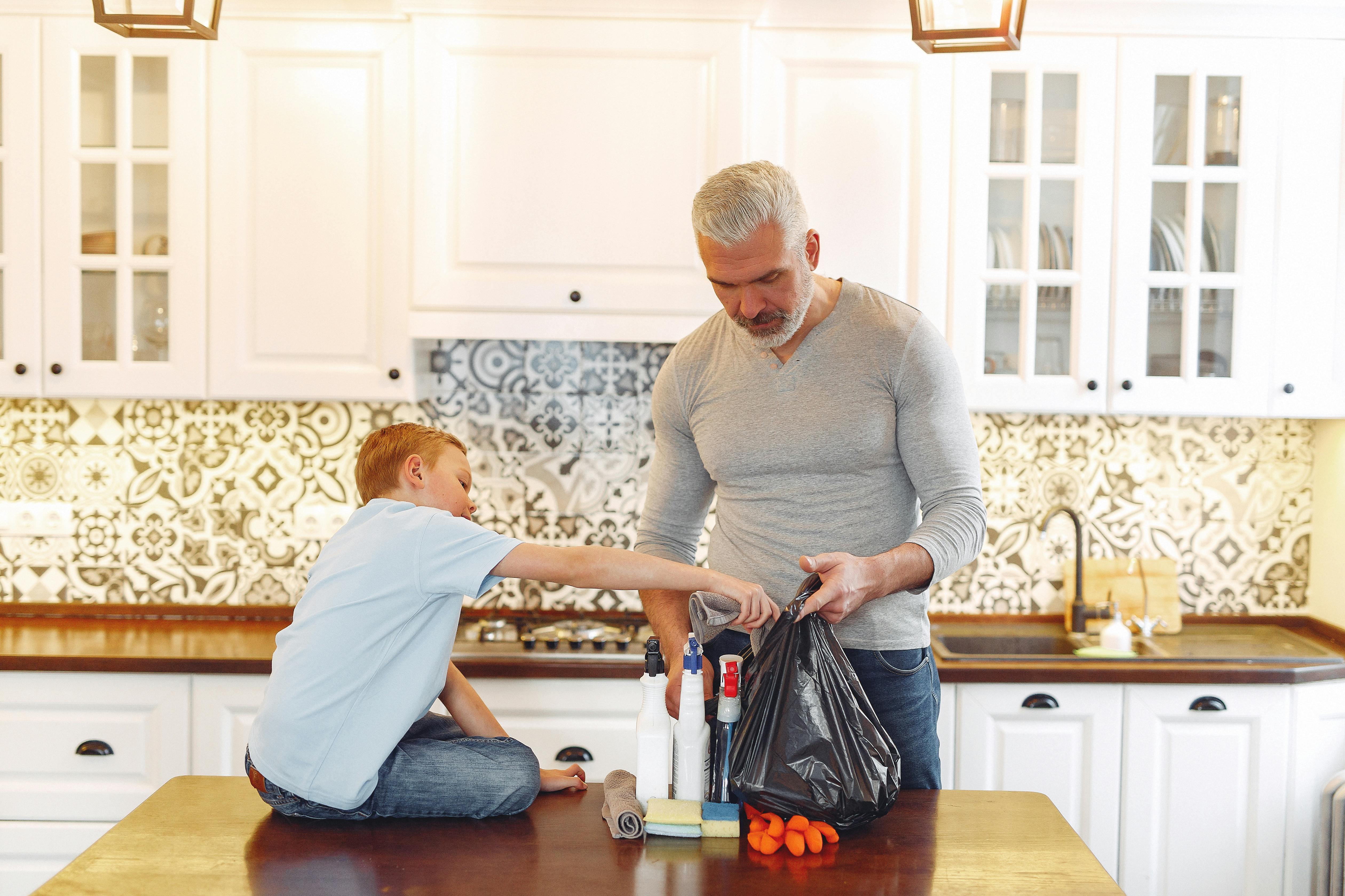 A parent and child gathering supplies before cleaning.