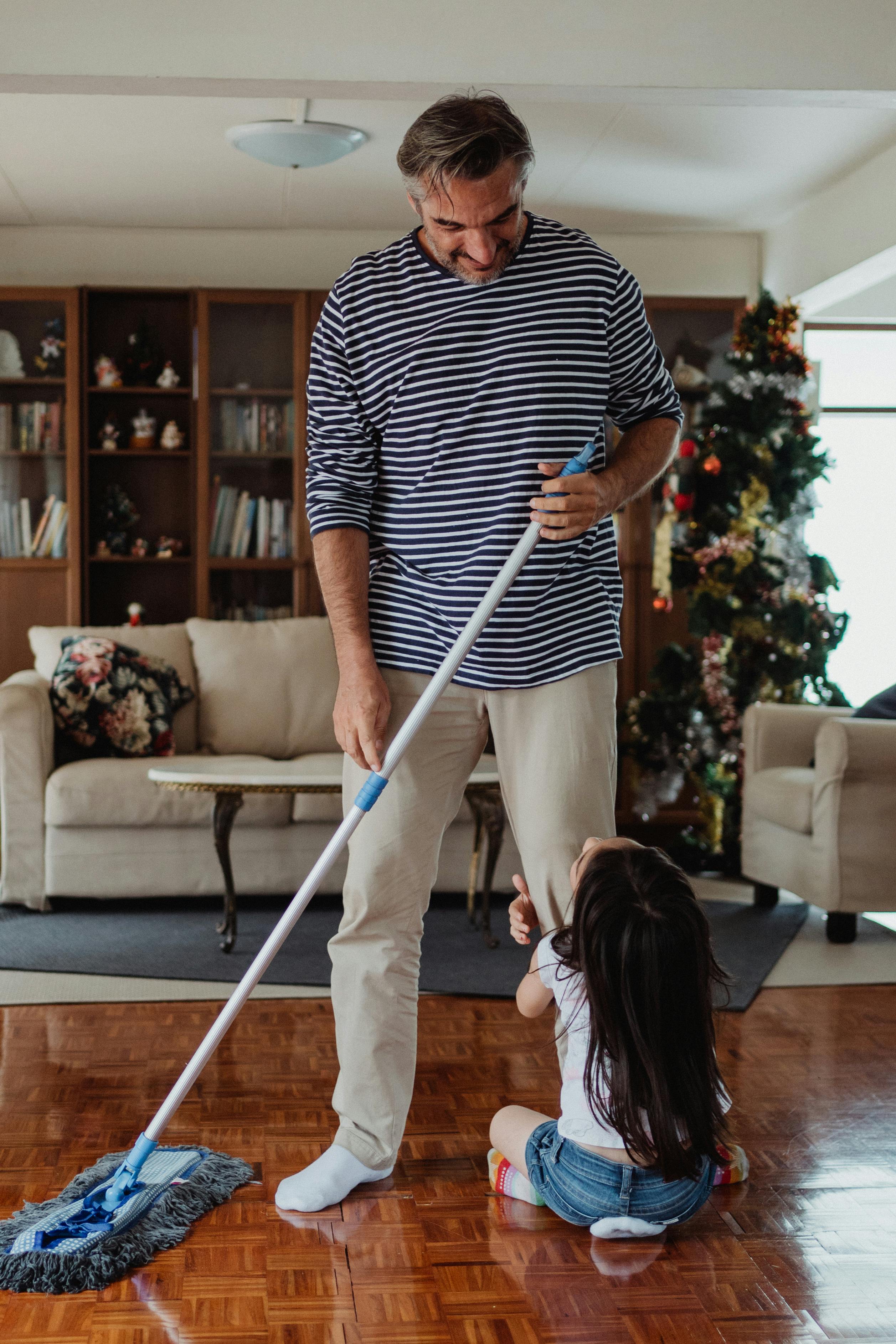 Siblings comparing chores while a parent guides the conversation